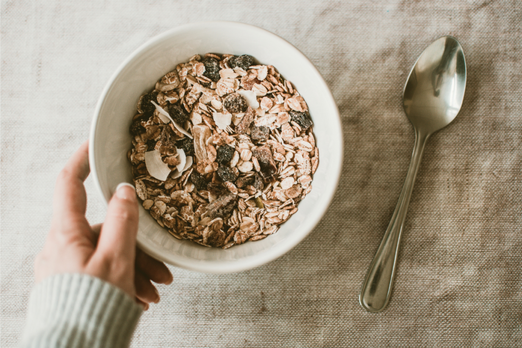 hand holding a bowl of vegan cereal
