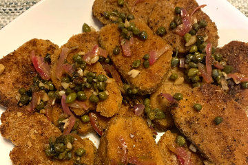 serving platter full of vegan chicken piccata topped with capers